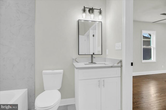 605 Northside Ave, Richmond, VA 23222 - full bath featuring vanity, toilet, baseboards, wood finished floors, and a bath