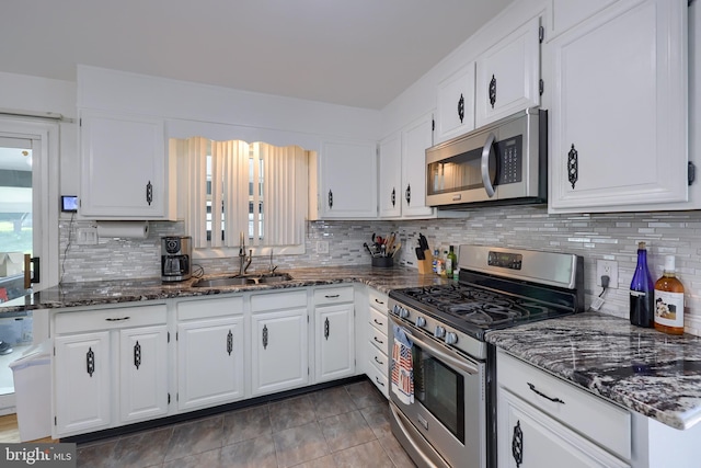 kitchen with a sink, appliances with stainless steel finishes, and white cabinets