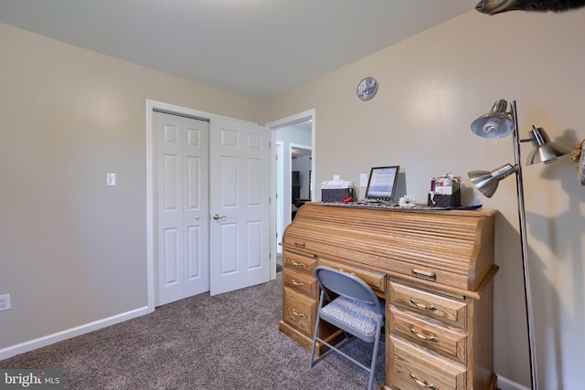 office with dark colored carpet and baseboards