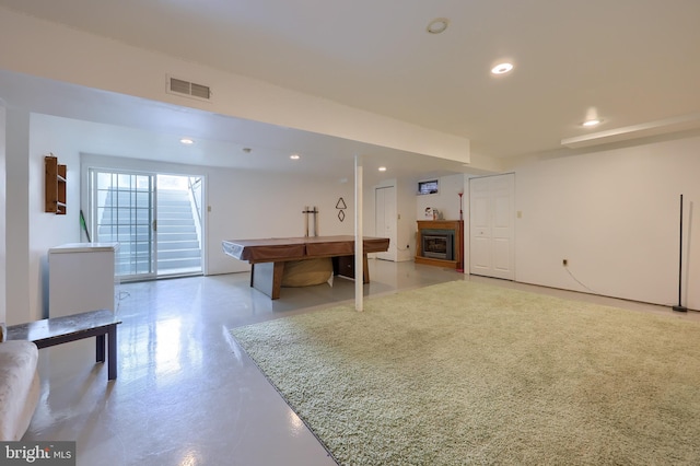 interior space with a fireplace, recessed lighting, and visible vents