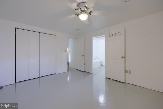 unfurnished bedroom with finished concrete floors, ceiling fan, and a closet