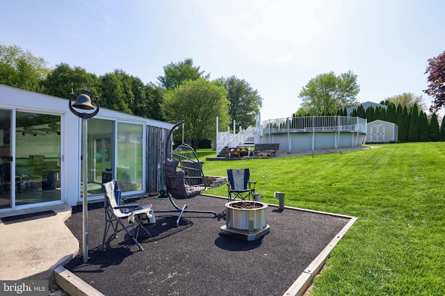 view of yard with a storage unit, an outdoor structure, and an outdoor pool