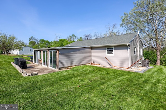 back of house with a lawn, a patio area, and central AC