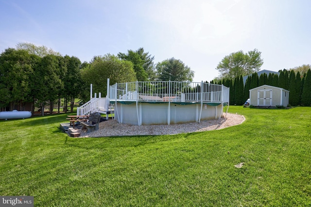 view of swimming pool featuring a yard, an outdoor structure, a shed, and a covered pool