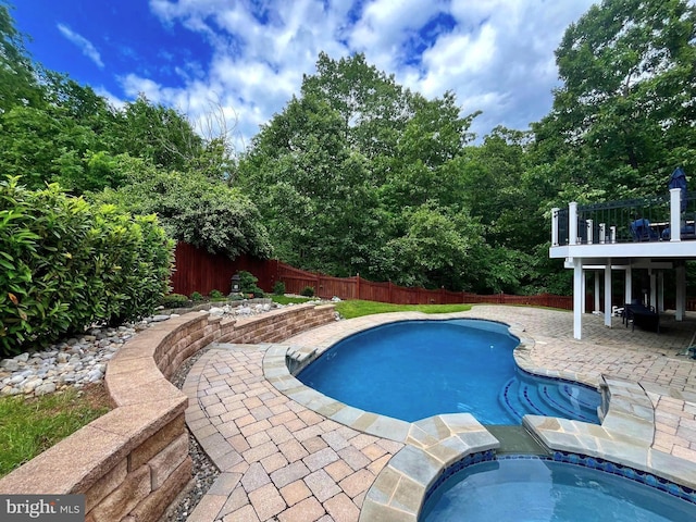 view of pool with a fenced backyard, a patio area, and an in-ground hot tub