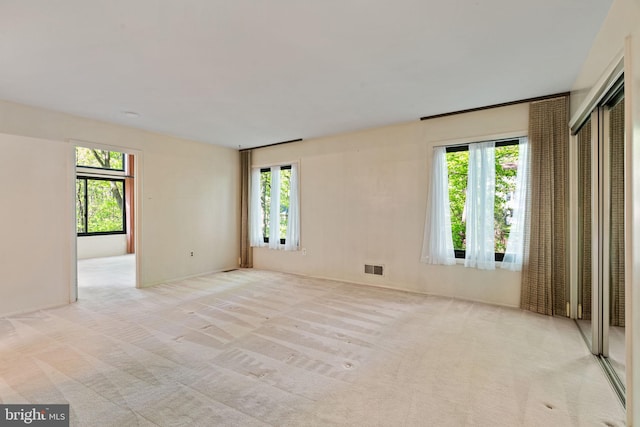 carpeted empty room with visible vents