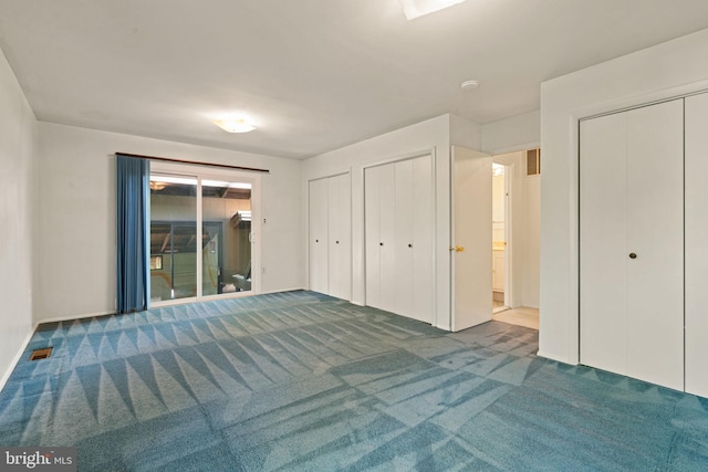 unfurnished bedroom with carpet flooring, multiple closets, access to exterior, baseboards, and visible vents