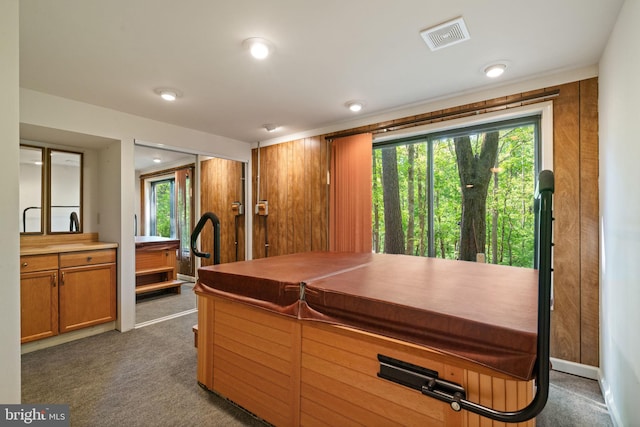 kitchen featuring visible vents, brown cabinetry, and dark colored carpet