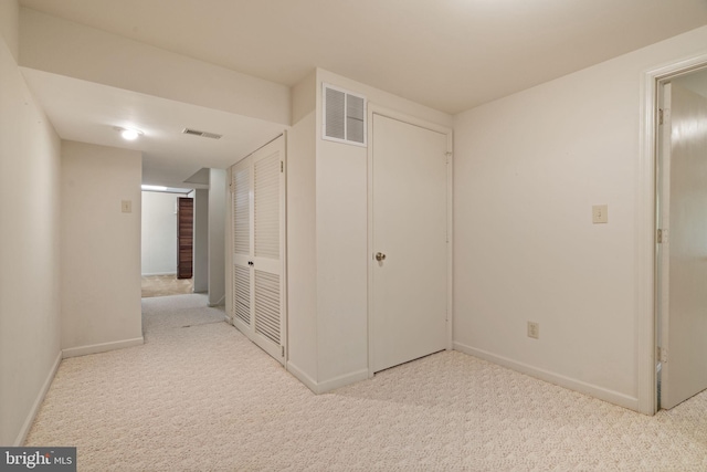 unfurnished bedroom with carpet flooring, baseboards, and visible vents