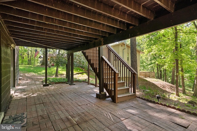 view of patio / terrace with stairs and fence