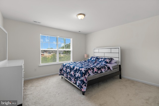 bedroom with carpet floors, baseboards, and visible vents