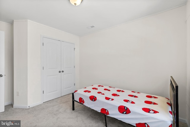 carpeted bedroom with baseboards, a closet, and visible vents