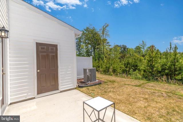 view of yard featuring a patio area and central air condition unit