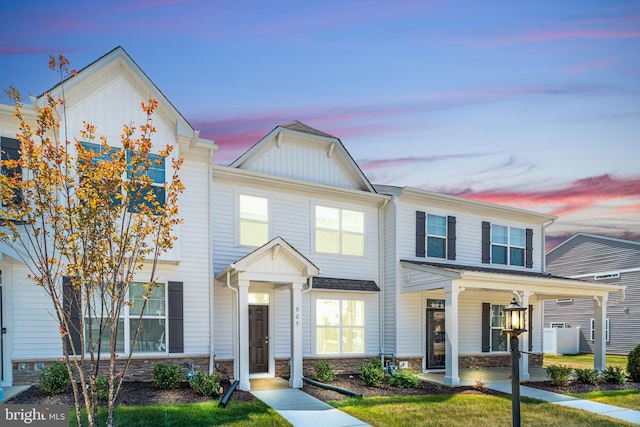 multi unit property featuring board and batten siding, covered porch, and stone siding