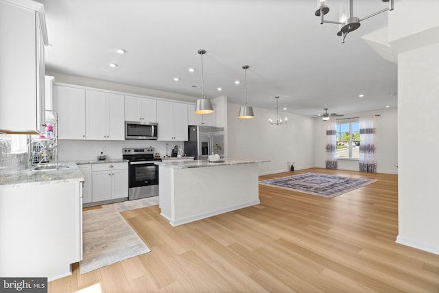 kitchen with open floor plan, a center island, recessed lighting, tasteful backsplash, and appliances with stainless steel finishes