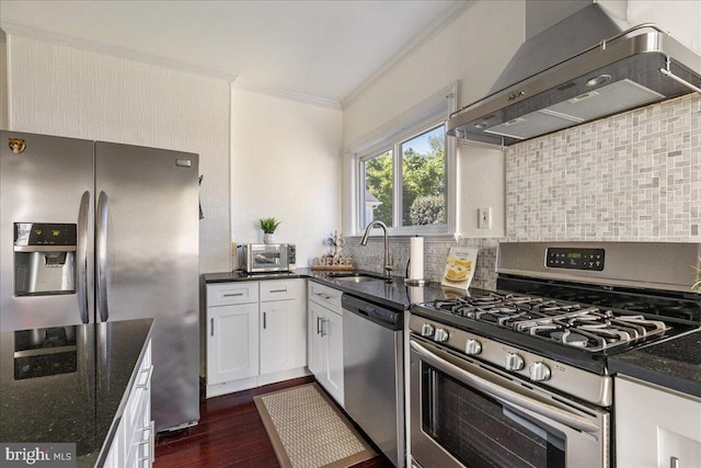 kitchen with ornamental molding, wall chimney exhaust hood, a sink, dark wood finished floors, and appliances with stainless steel finishes