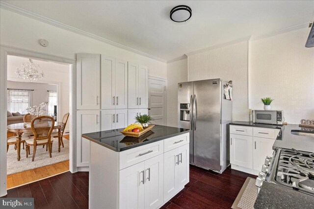 kitchen featuring stainless steel fridge, ornamental molding, dark wood-style flooring, and white cabinetry