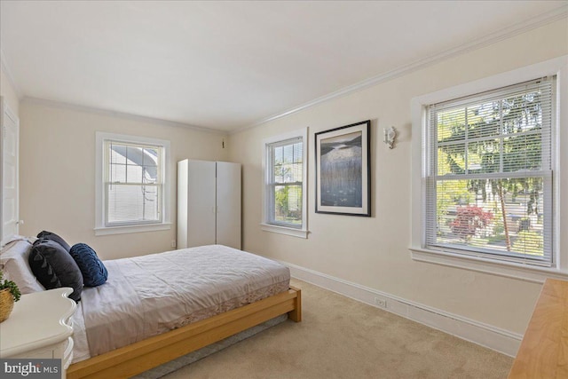 carpeted bedroom with baseboards and ornamental molding