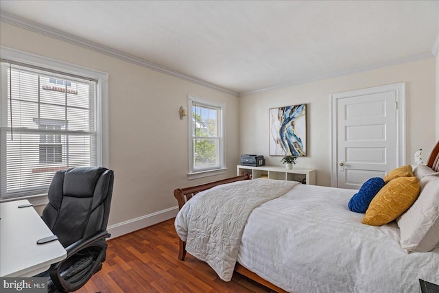 bedroom with crown molding, baseboards, and wood finished floors