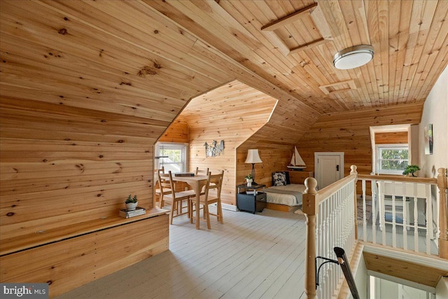 bonus room with wooden ceiling, vaulted ceiling, wood walls, and hardwood / wood-style floors