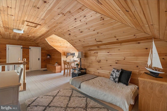 bedroom with wooden walls, hardwood / wood-style flooring, wood ceiling, and lofted ceiling