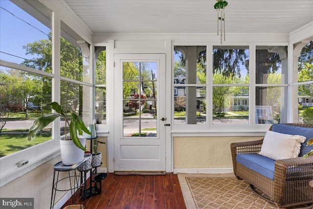 sunroom with ornamental molding and hardwood / wood-style floors