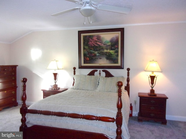 carpeted bedroom featuring baseboards, ornamental molding, ceiling fan, and lofted ceiling