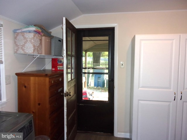 doorway featuring crown molding and vaulted ceiling