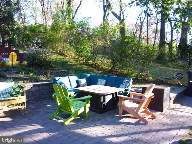 view of patio featuring a fenced backyard and a fire pit