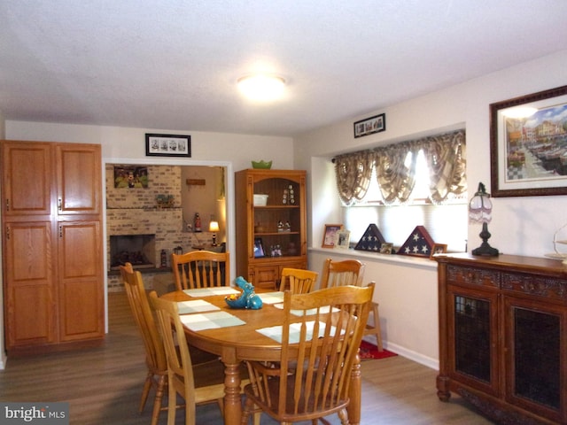 dining room with a fireplace and light wood-type flooring