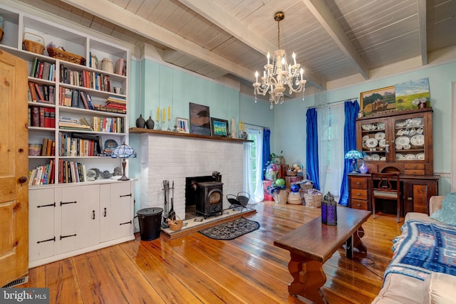 3909 Stoney Creek Rd, Edinburg, VA 22824 - living area with a wood stove, wood-type flooring, beamed ceiling, a chandelier, and wood ceiling