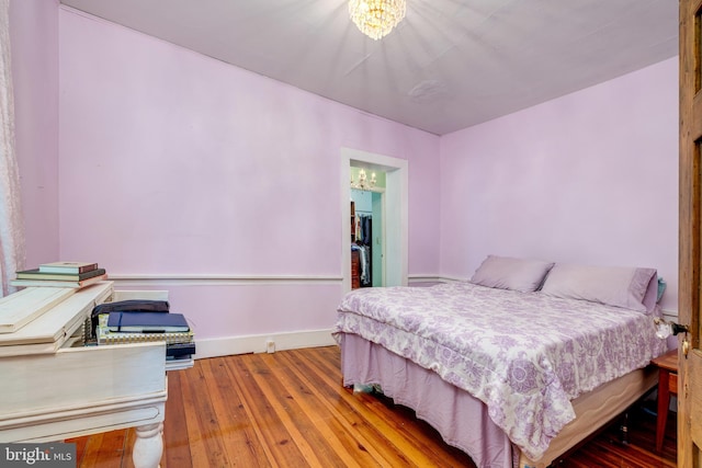3909 Stoney Creek Rd, Edinburg, VA 22824 - bedroom featuring a chandelier, wood-type flooring, and baseboards