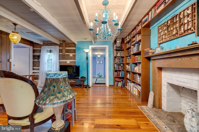 3909 Stoney Creek Rd, Edinburg, VA 22824 - living area featuring a fireplace with flush hearth, wood-type flooring, beam ceiling, and a chandelier