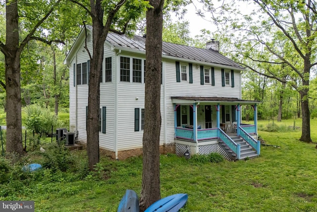 3909 Stoney Creek Rd, Edinburg, VA 22824 - view of front of house with covered porch, a chimney, a standing seam roof, a front lawn, and metal roof