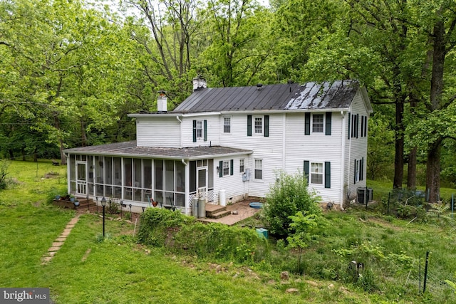 3909 Stoney Creek Rd, Edinburg, VA 22824 - rear view of property featuring a sunroom, a chimney, central air condition unit, a yard, and a view of trees