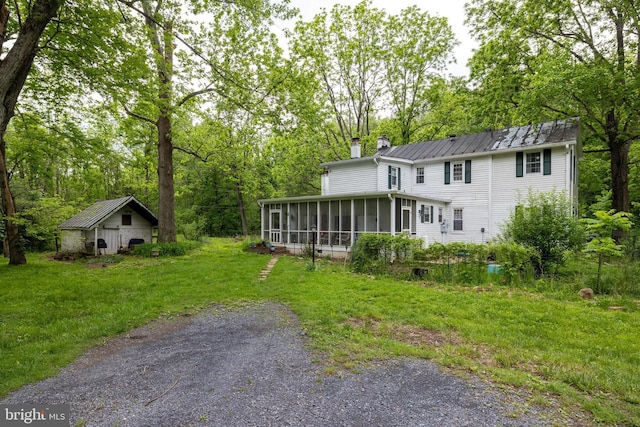 3909 Stoney Creek Rd, Edinburg, VA 22824 - rear view of house with a sunroom, a chimney, a yard, and an outdoor structure