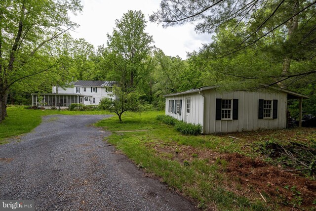 3909 Stoney Creek Rd, Edinburg, VA 22824 - view of front of house featuring board and batten siding and gravel driveway