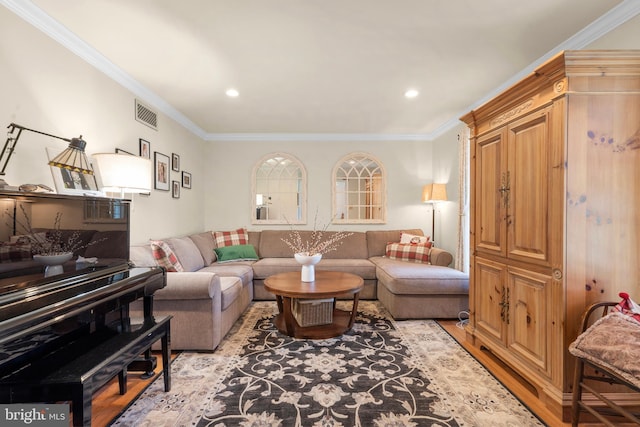 living room with recessed lighting, visible vents, ornamental molding, and light wood-style flooring