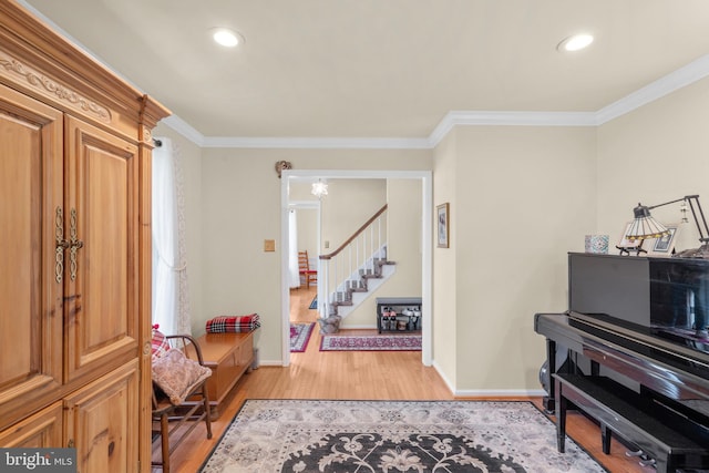 entryway featuring stairs, baseboards, light wood finished floors, ornamental molding, and recessed lighting