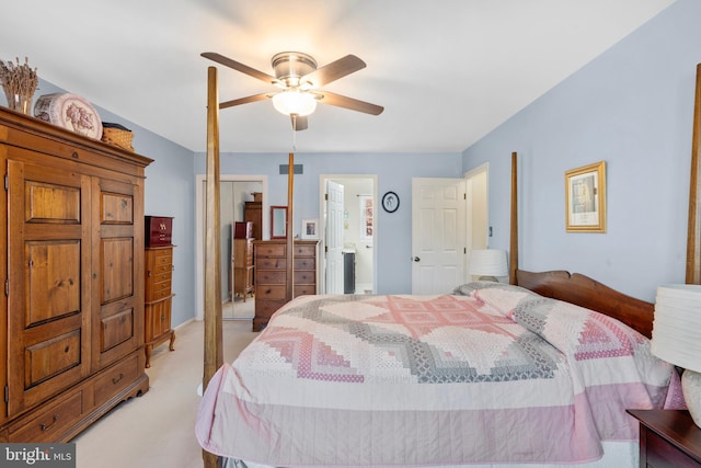 bedroom featuring light colored carpet, a ceiling fan, ensuite bathroom, and visible vents