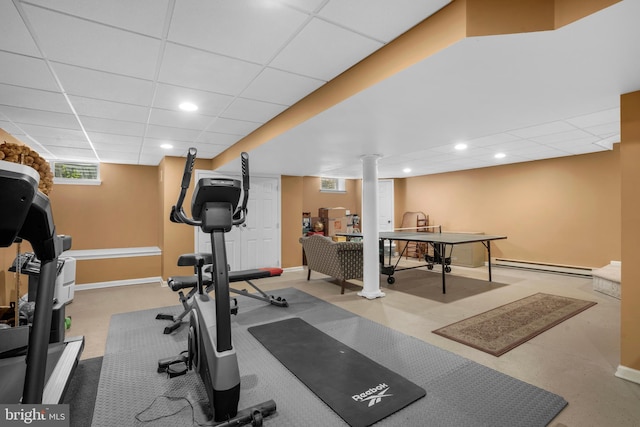 exercise room with baseboards, a baseboard heating unit, recessed lighting, and a paneled ceiling