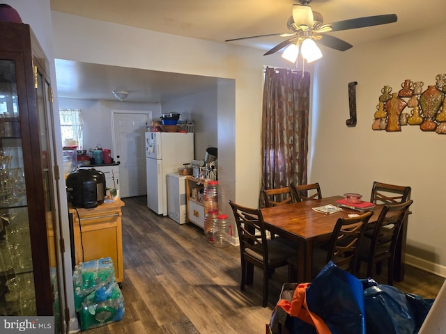 dining room with a ceiling fan and dark wood finished floors