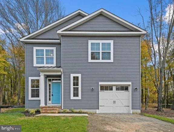 view of front of property with driveway, a garage, and a front yard