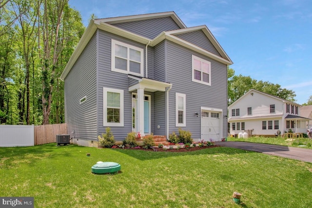 view of front of home featuring an attached garage, cooling unit, and driveway