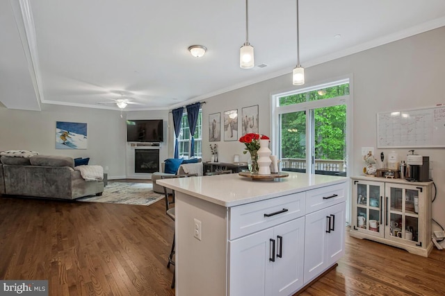 kitchen featuring white cabinets, ceiling fan, dark wood-style flooring, pendant lighting, and light countertops