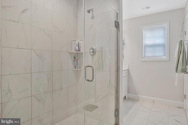 full bathroom featuring marble finish flooring, a shower stall, and baseboards