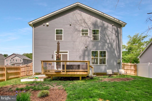 back of house with a deck