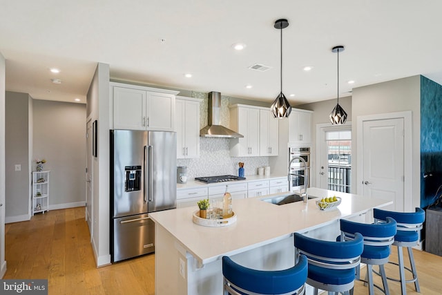2320 Field Point Rd Unit 4-405, Herndon, VA 20171 - kitchen featuring stainless steel appliances, wall chimney exhaust hood, a sink, a center island with sink, and tasteful backsplash