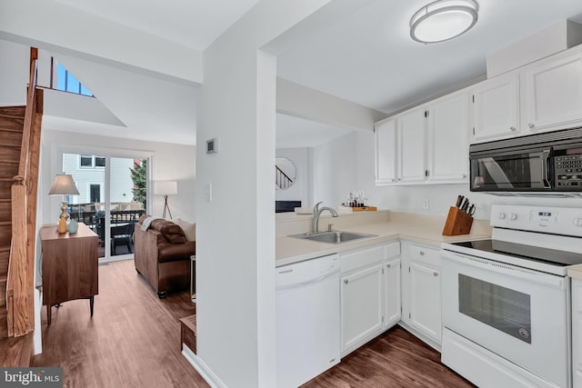 kitchen featuring dark wood-style flooring, white appliances, light countertops, white cabinets, and a sink