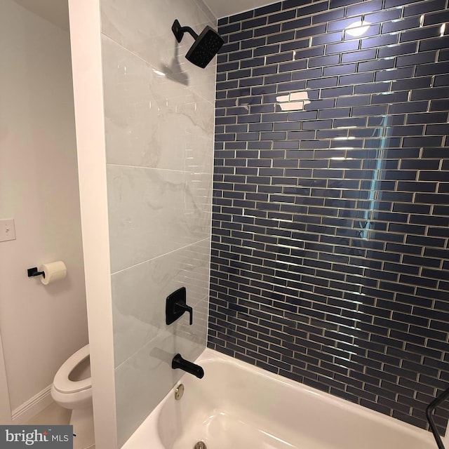 full bath featuring toilet, baseboards, and shower / tub combination